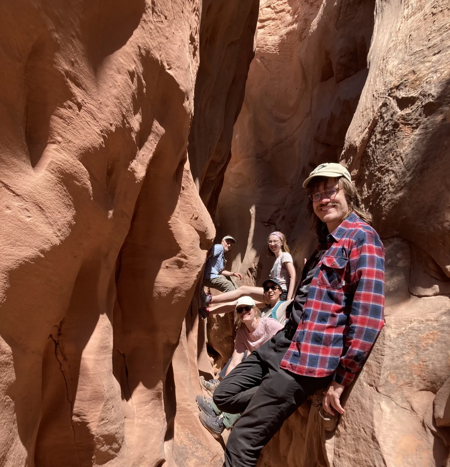 Members of the SMRFS field team sitting in a slot canyon